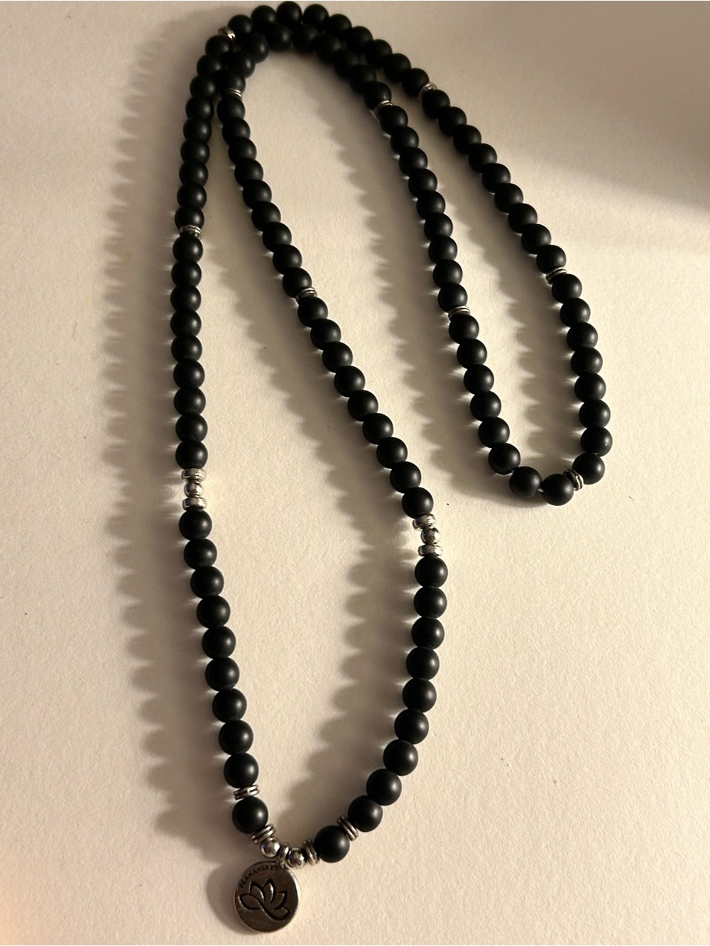 Pranaheart Necklace Black Mala beads sections, silver spacers stretch, Lotus tag